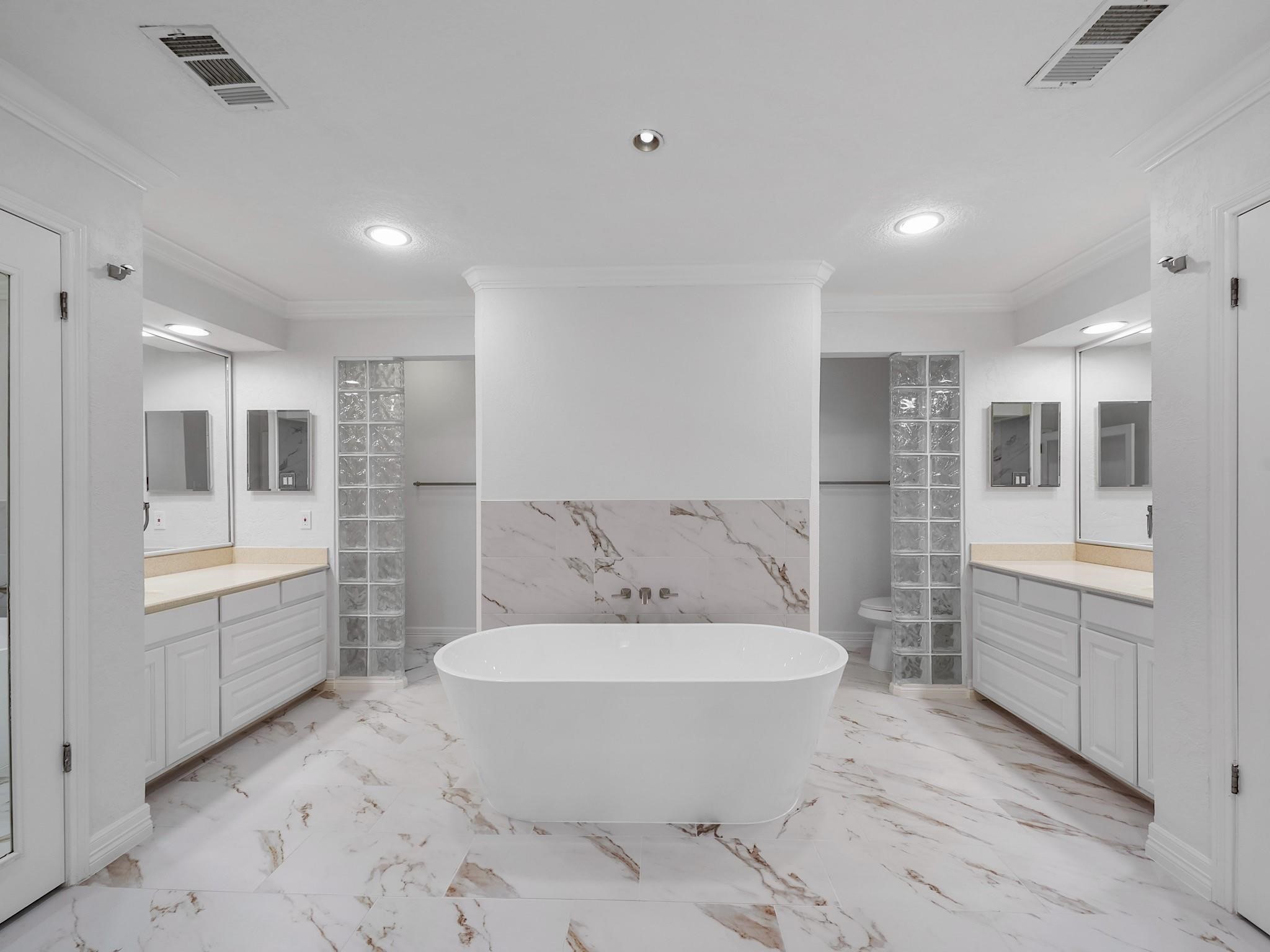 910 Enclave Parkway Houston, TX 77077 - Photo 20 of 42 Recently renovated spa bath with two distinct vanities for easy mornings.