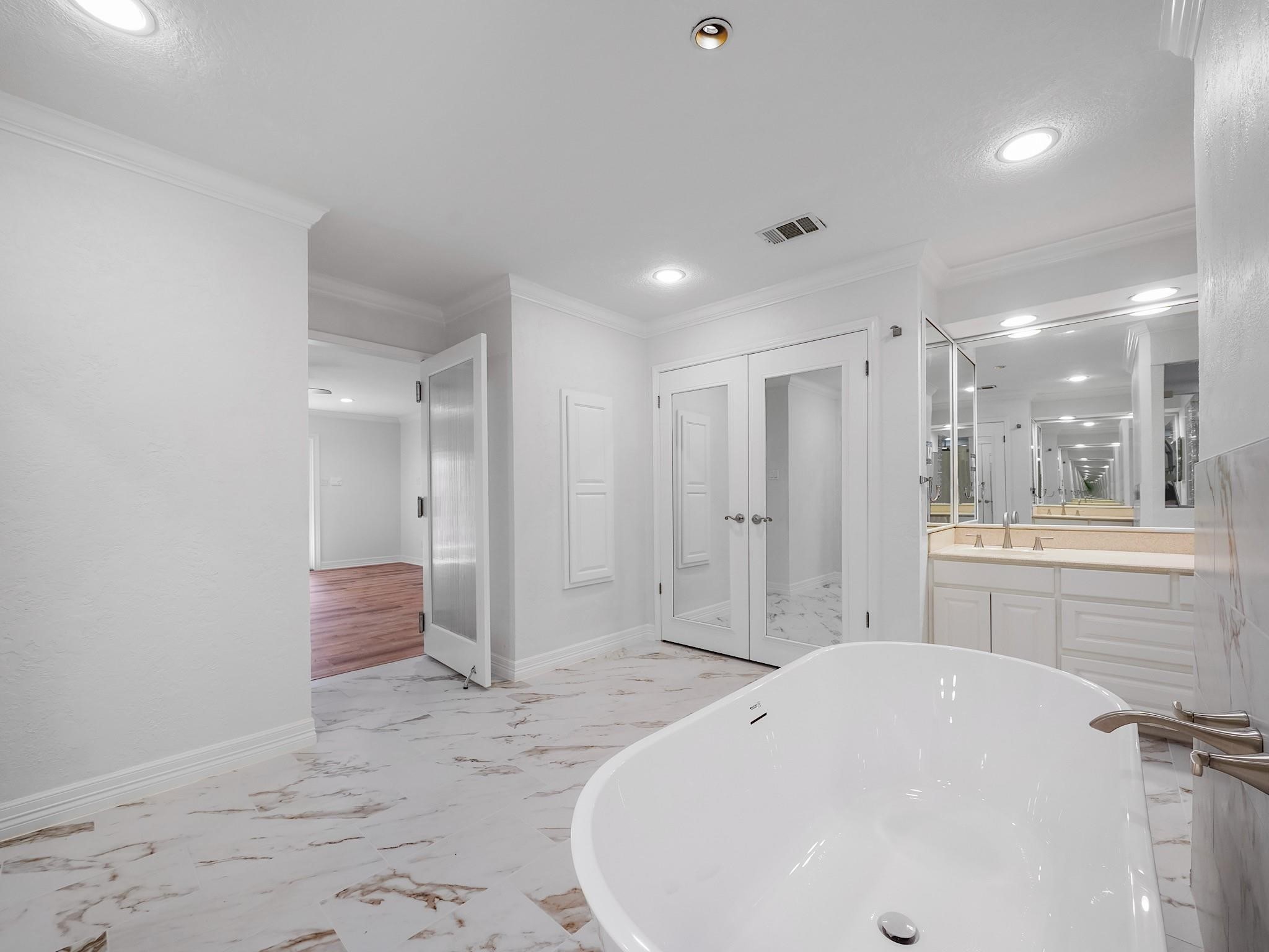 910 Enclave Parkway Houston, TX 77077 - Photo 22 of 42 Luxurious freestanding soaking tub with modern tile surround—unwind in style.