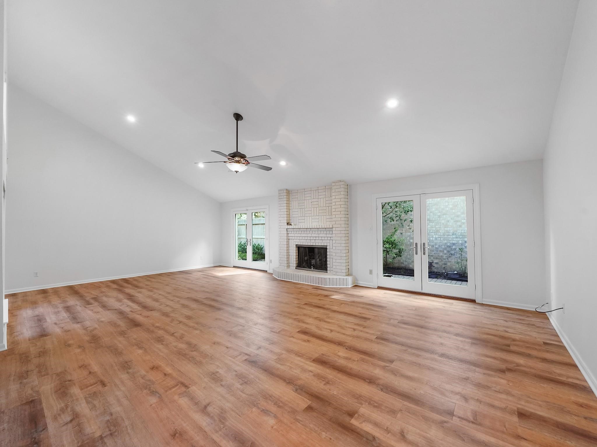 910 Enclave Parkway Houston, TX 77077 - Photo 4 of 42 Expansive living room with fireplace and flexible zones—perfect for multiple seating areas or a piano.