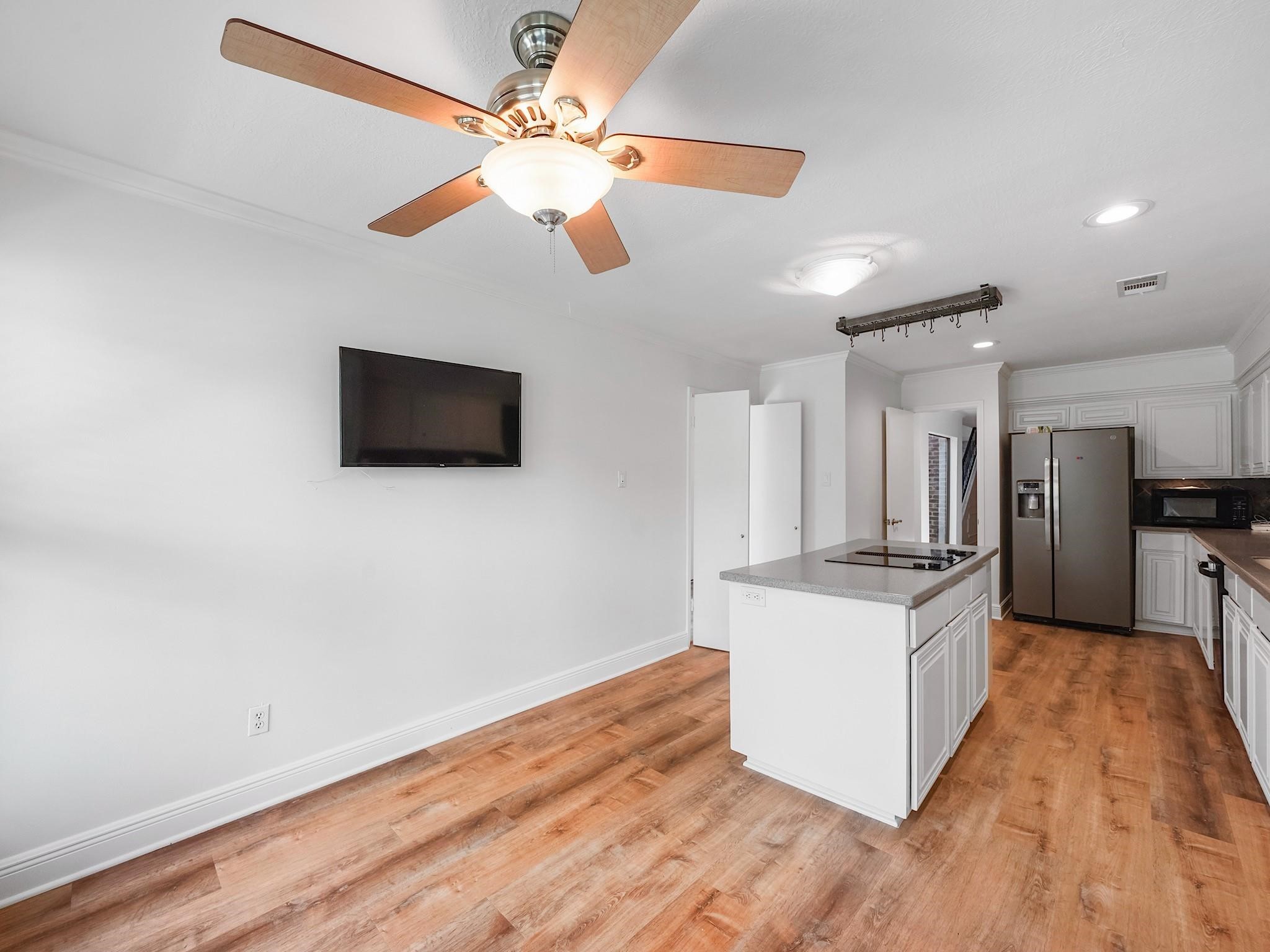 910 Enclave Parkway Houston, TX 77077 - Photo 10 of 42 Chef’s kitchen with island cooktop, double ovens, sleek counters, and plentiful storage.