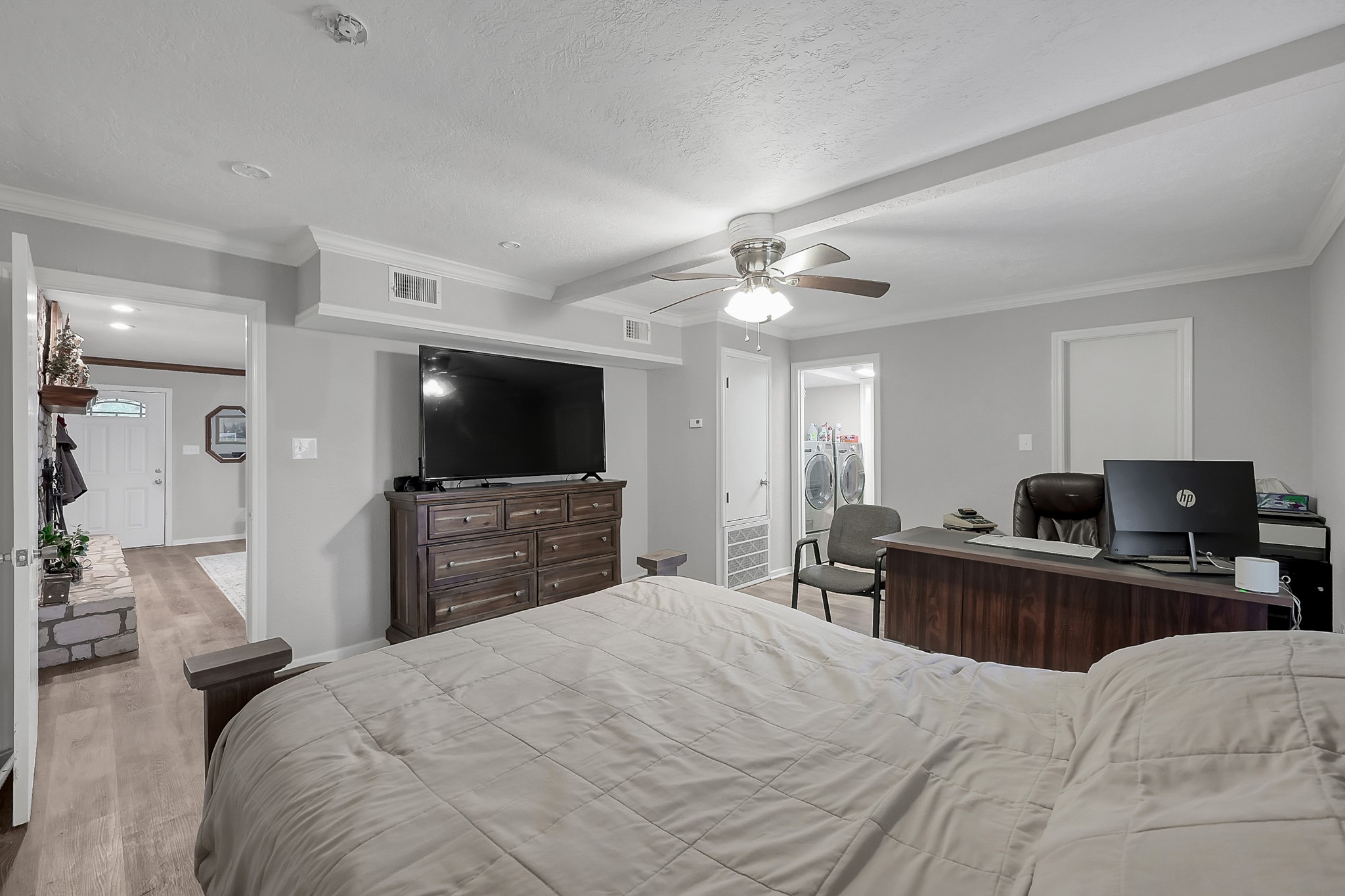 80 Nettie Phillips Road Coldspring, TX 77331 - Photo 16 of 49 Downstairs Primary Suite with views into the Living Area to the left and the utility to the right.