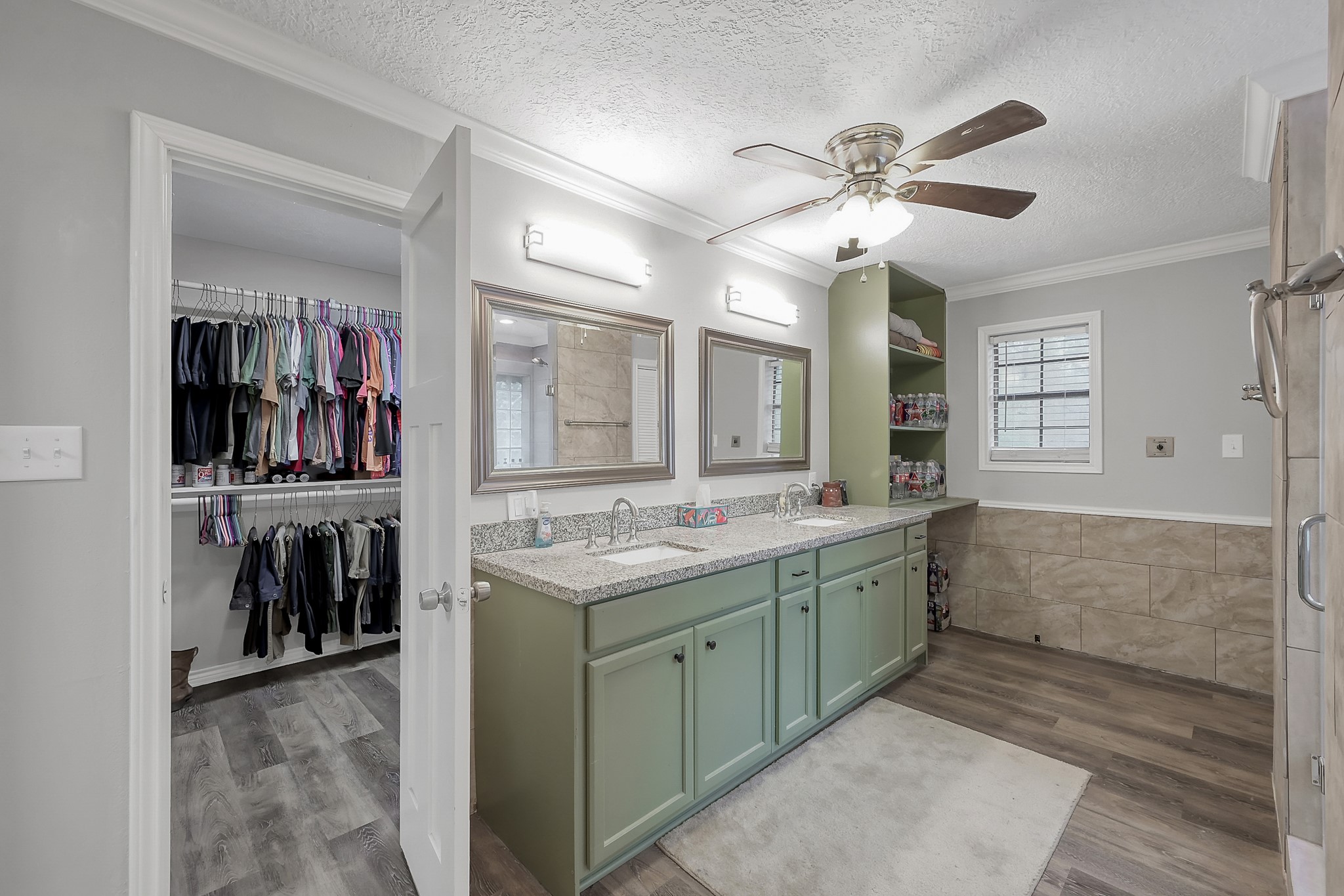 80 Nettie Phillips Road Coldspring, TX 77331 - Photo 17 of 49 Downstairs Primary En-Suite Bath complete with double sinks, granite countertops and walk-in closet.