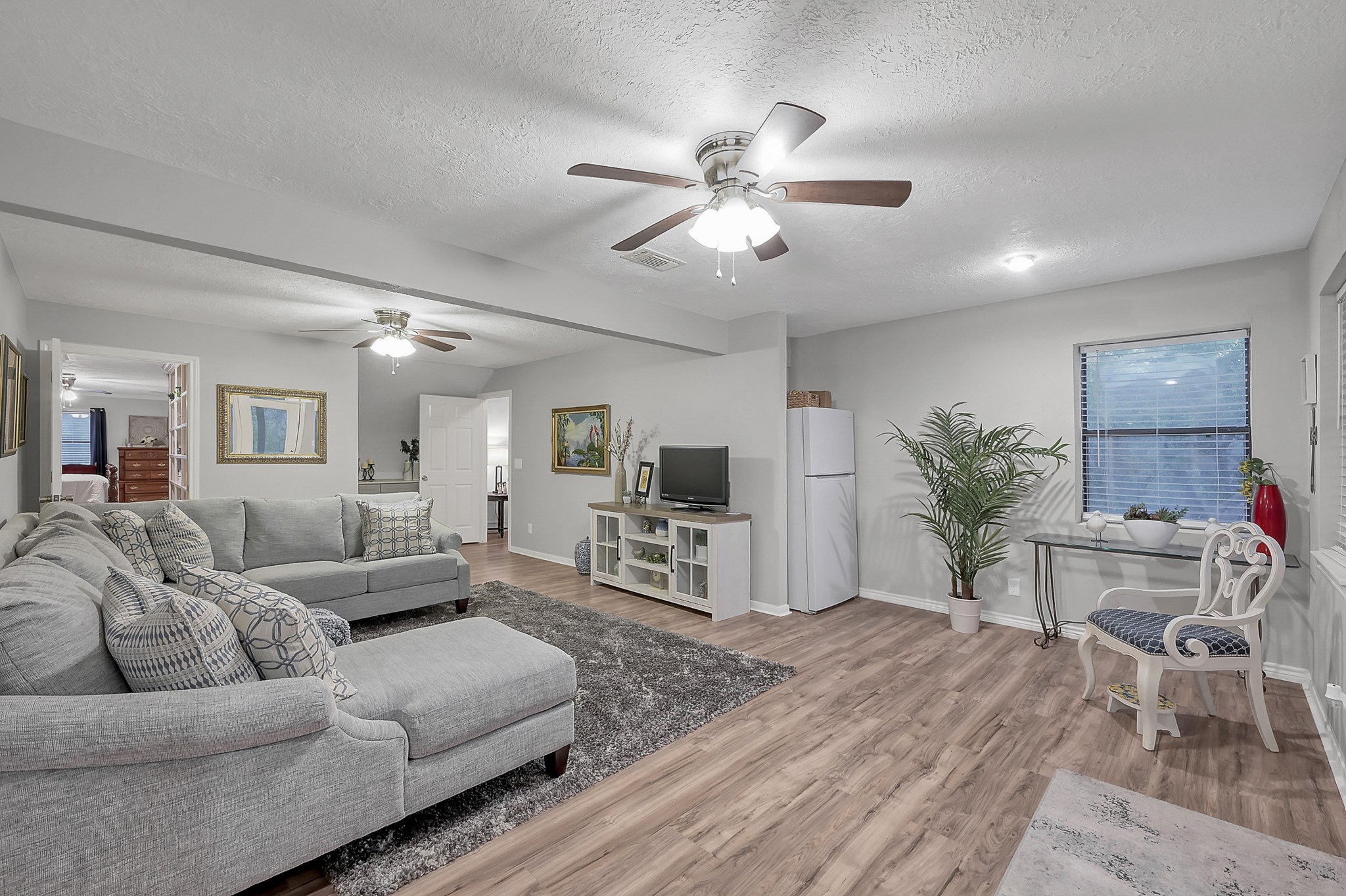 80 Nettie Phillips Road Coldspring, TX 77331 - Photo 21 of 49 Complimentary view of the upstairs Living Area with hidden refrigerator and multiple seating options.
