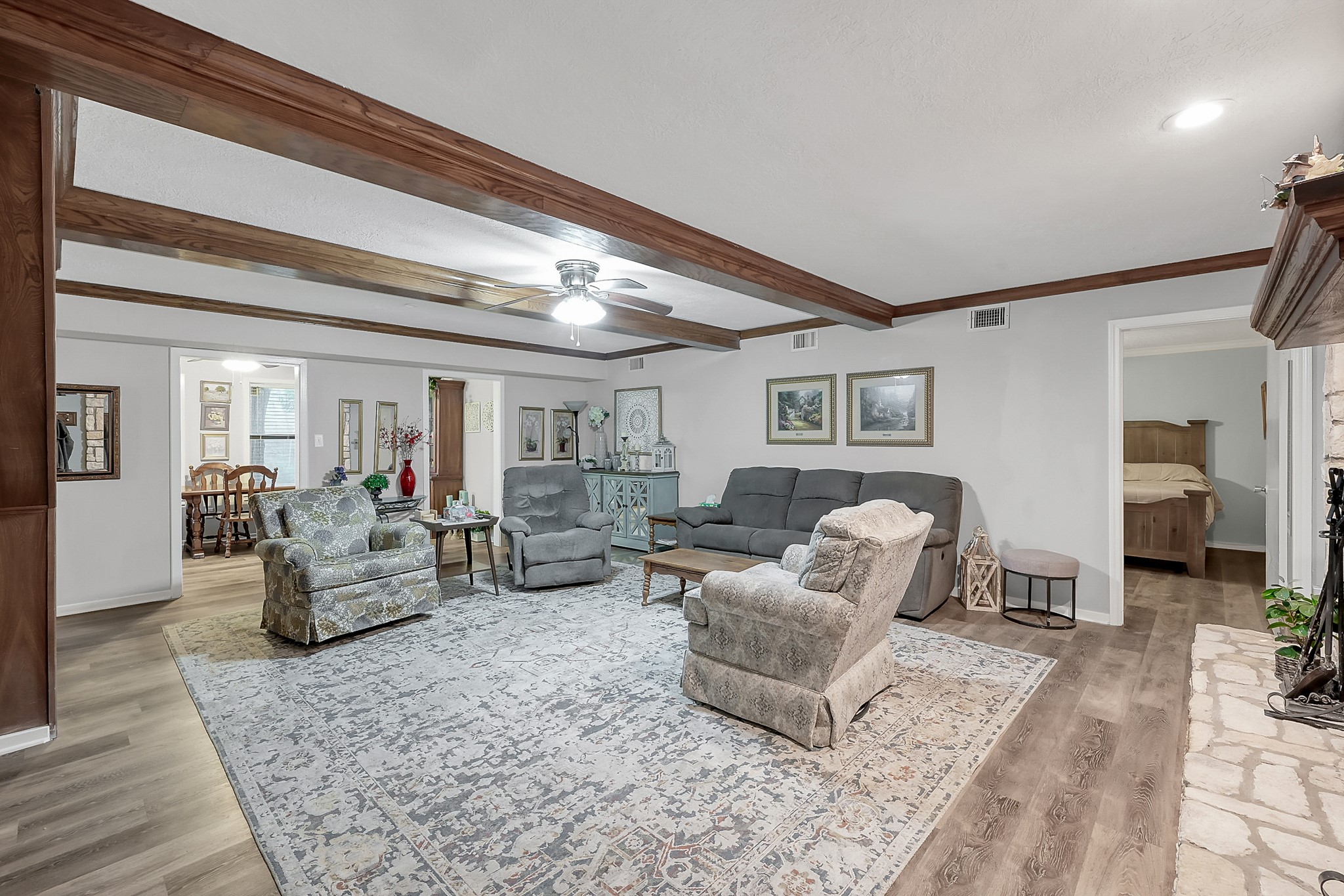 80 Nettie Phillips Road Coldspring, TX 77331 - Photo 7 of 49 Stepping into the home, you feel the warmth of the Living Area with Formal Dining situated just behind. The downstairs Primary Suite is located through the doorway on the right.