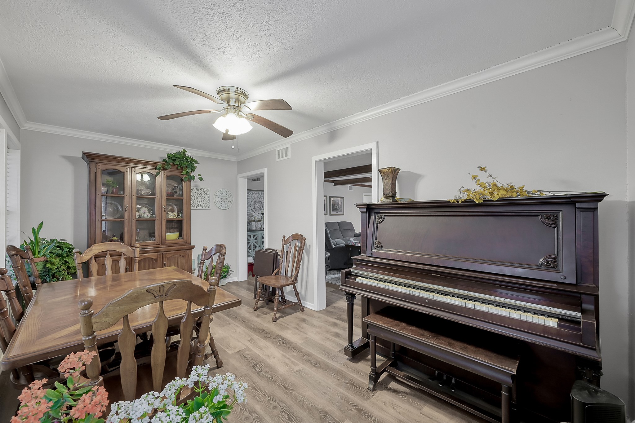 80 Nettie Phillips Road Coldspring, TX 77331 - Photo 10 of 49 Complimentary view of the Dining Room which is adjacent to the Living Area, complete with crown molding and ceiling fan.