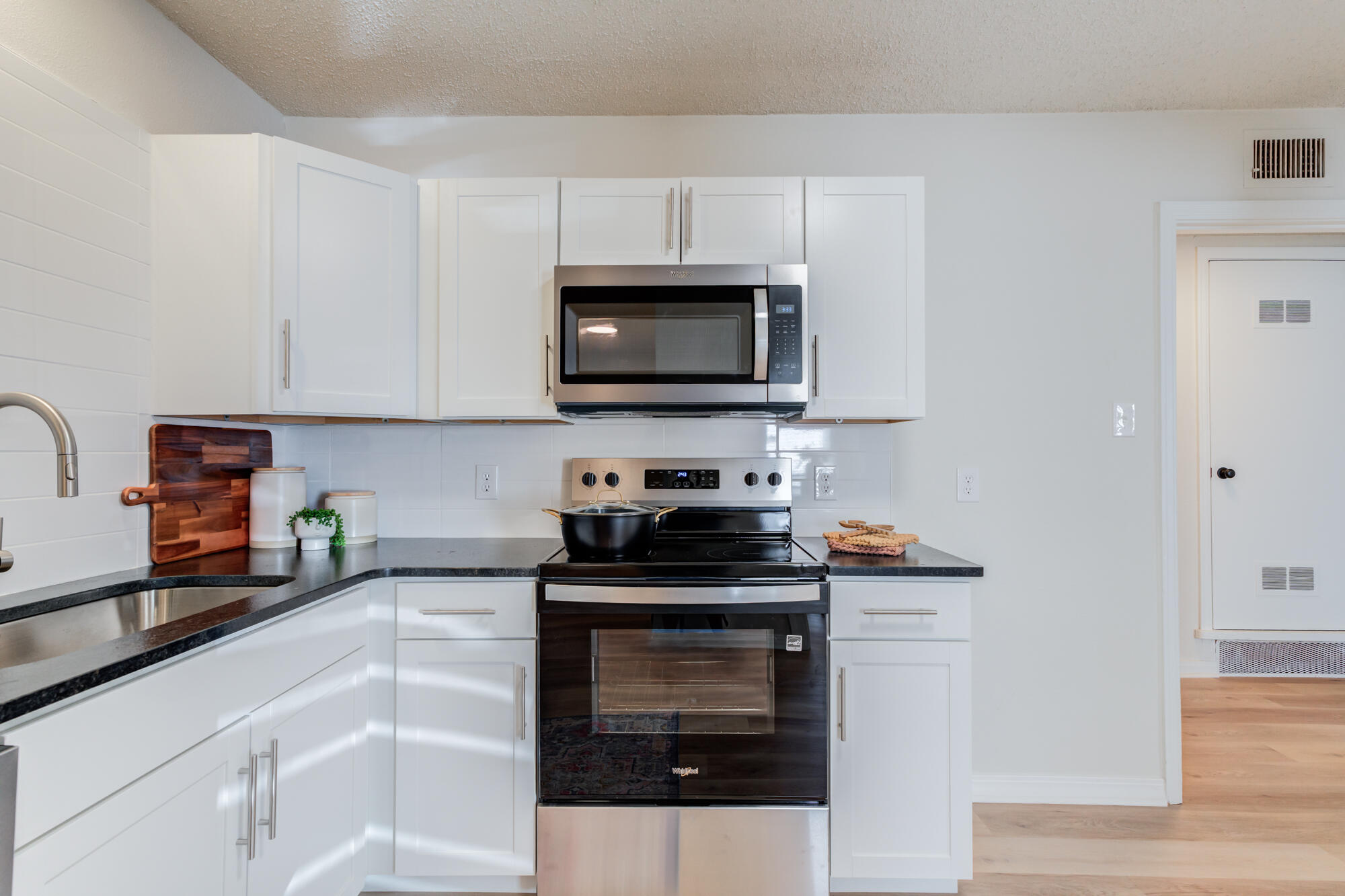 3610 30th Street Lubbock, TX 79410 - Photo 18 of 35 a kitchen with granite countertop a stove and a microwave