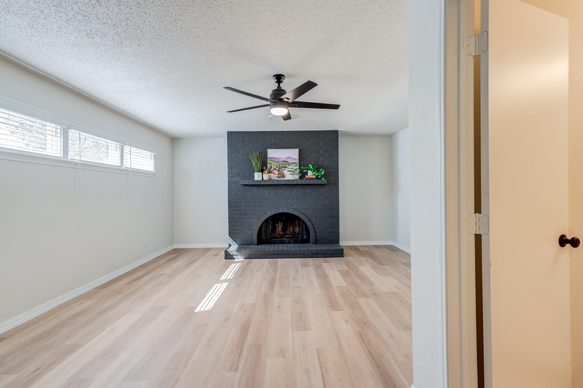 3610 30th Street Lubbock, TX 79410 - Photo 22 of 35 a view of a livingroom with a fireplace and a chandelier fan