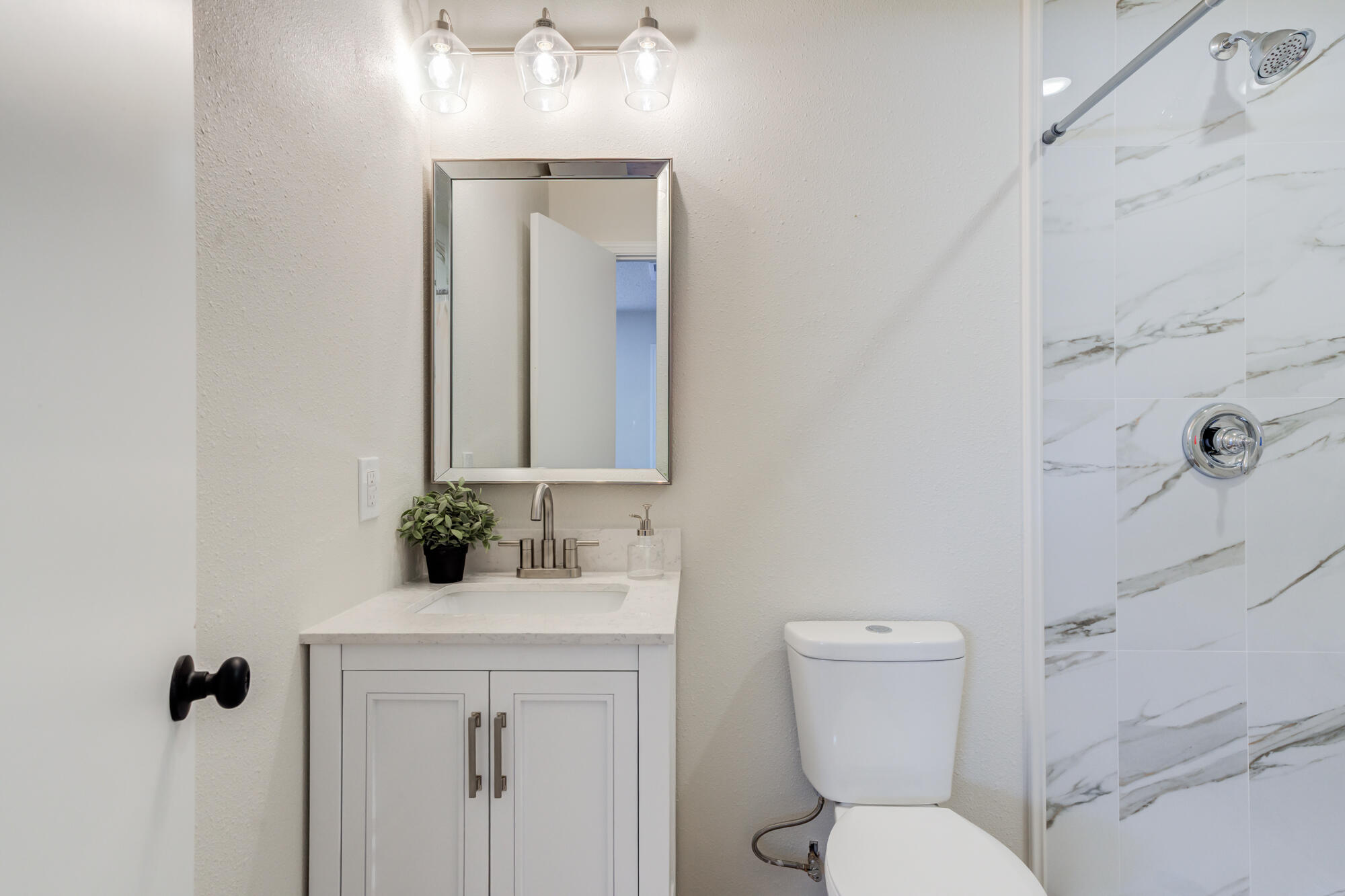 3610 30th Street Lubbock, TX 79410 - Photo 23 of 35 a bathroom with a toilet sink and mirror