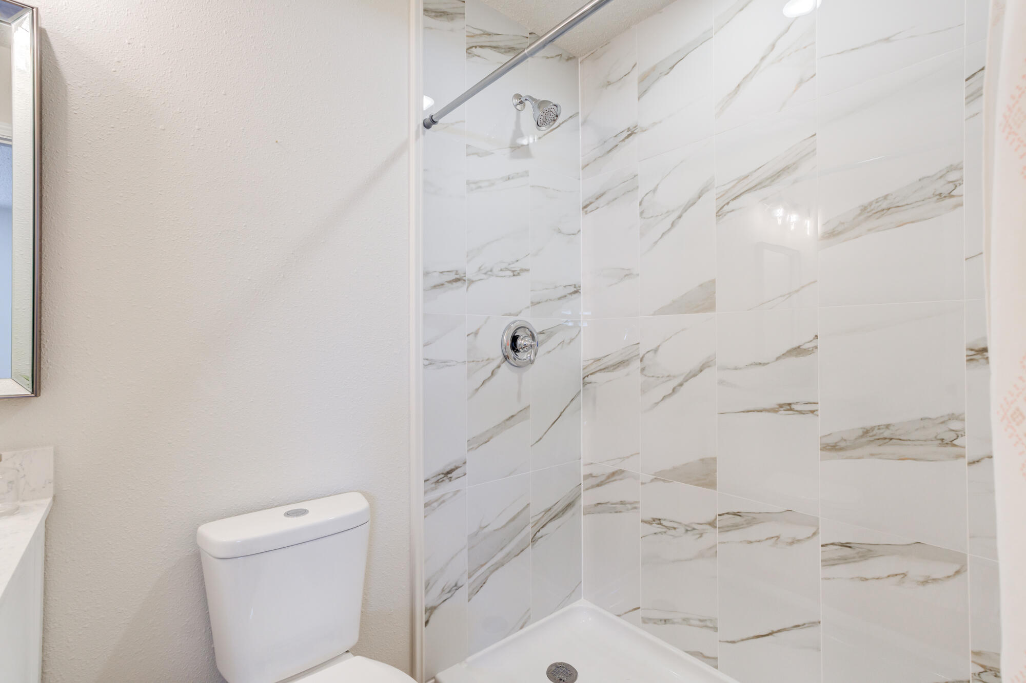 3610 30th Street Lubbock, TX 79410 - Photo 24 of 35 a bathroom with a shower and toilet
