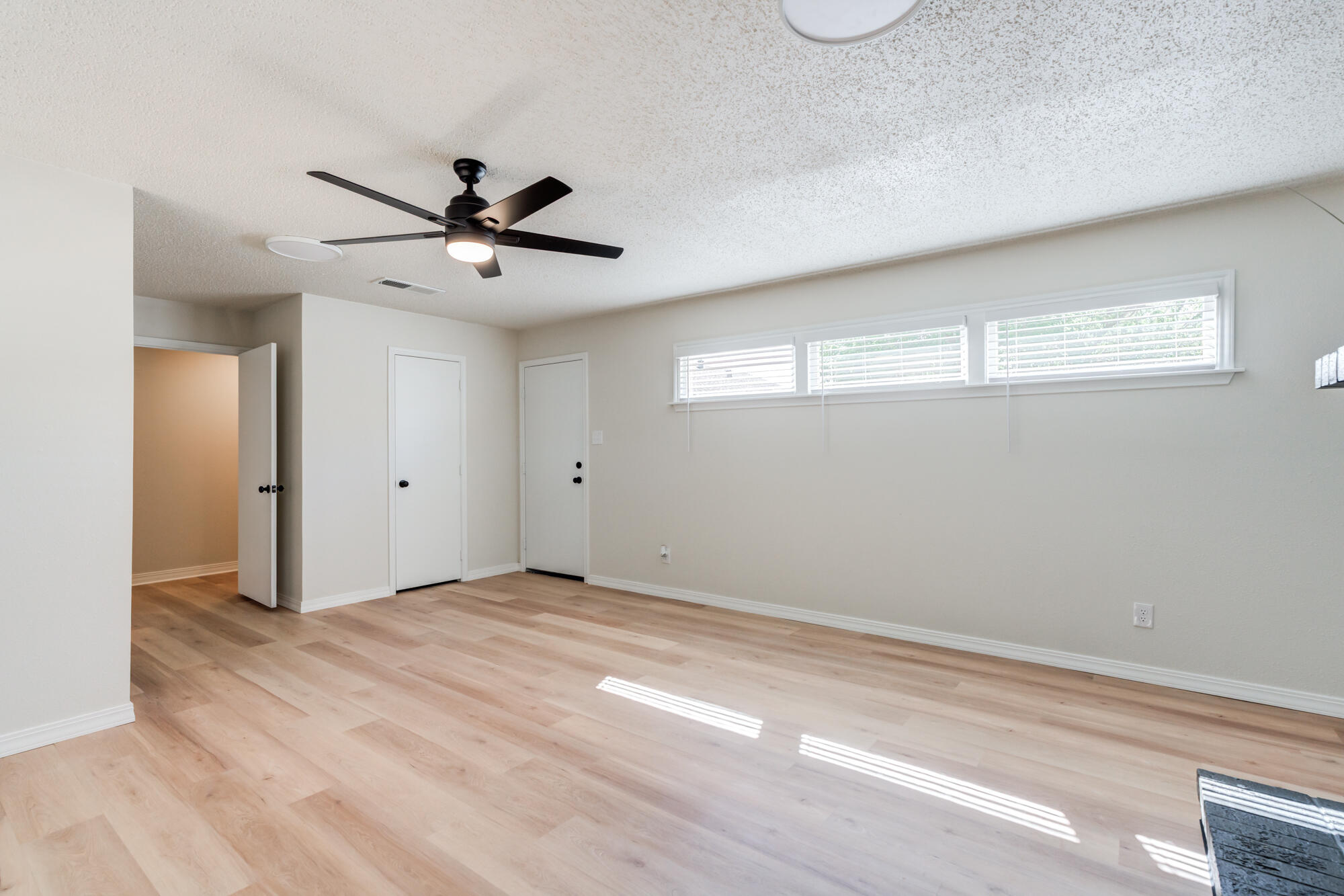 3610 30th Street Lubbock, TX 79410 - Photo 26 of 35 a view of a room with a ceiling fan and a window