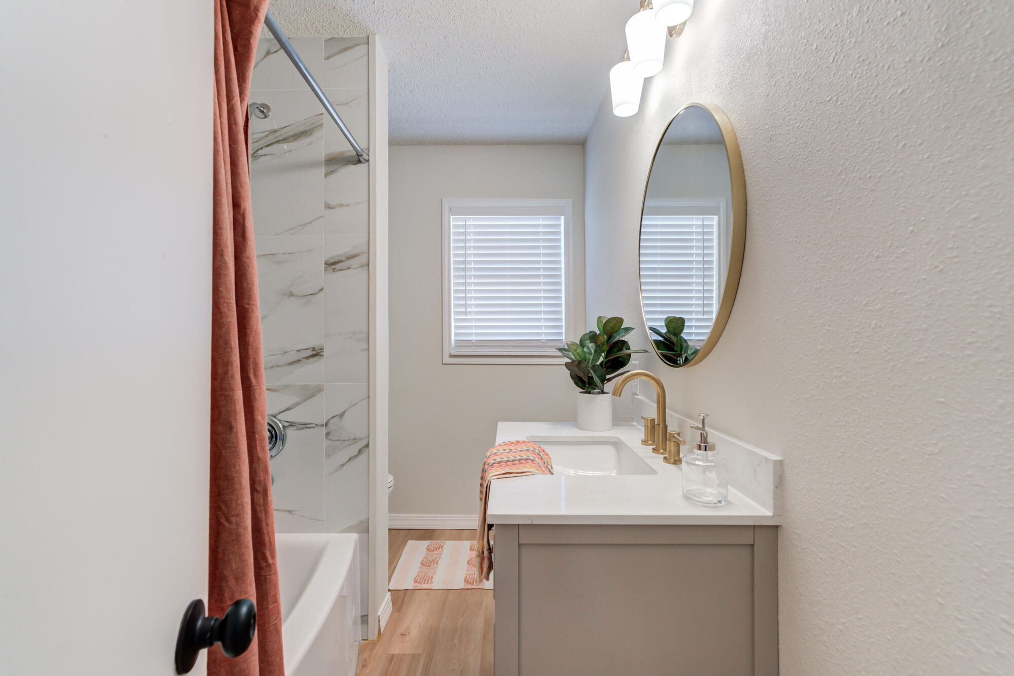 3610 30th Street Lubbock, TX 79410 - Photo 29 of 35 a bathroom with a sink and a mirror