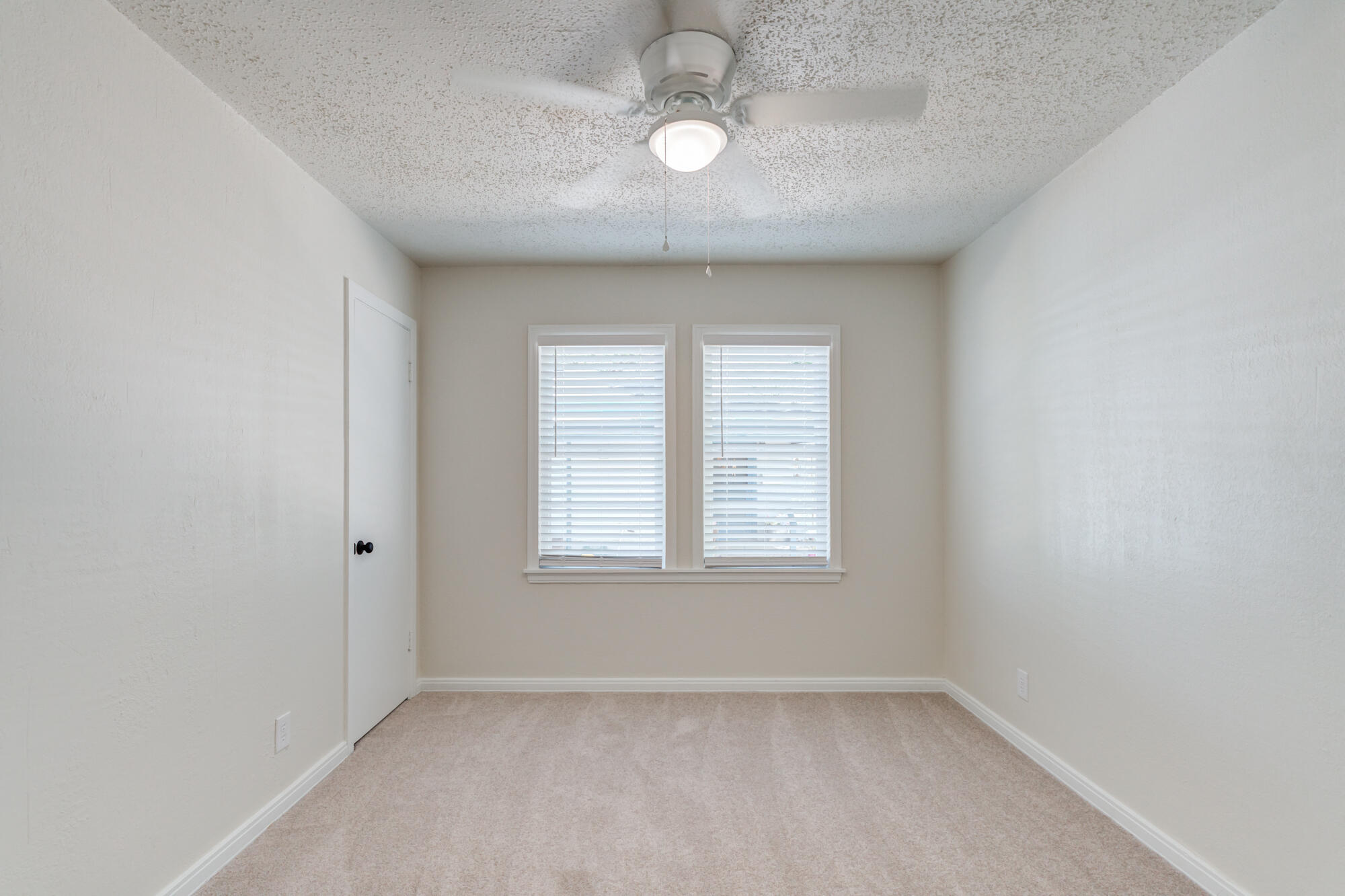 3610 30th Street Lubbock, TX 79410 - Photo 32 of 35 an empty room with windows and ceiling fan