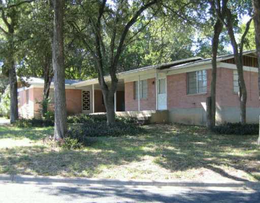 2400 Kinney Road Austin, TX 78704 - Photo 1 of 1 a view of a yard in front of a house with plants and large trees
