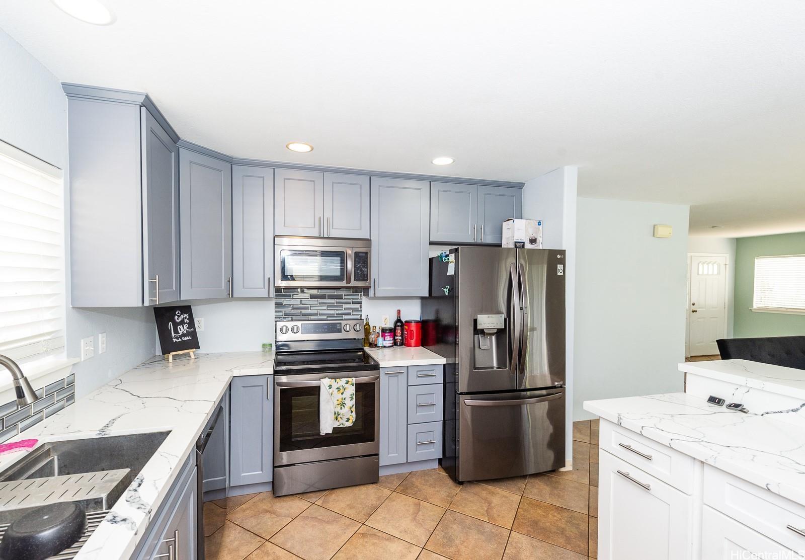92-7049 Elele Street, Unit 81 Kapolei, HI 96707 - Photo 11 of 21 a kitchen with a sink stove and refrigerator