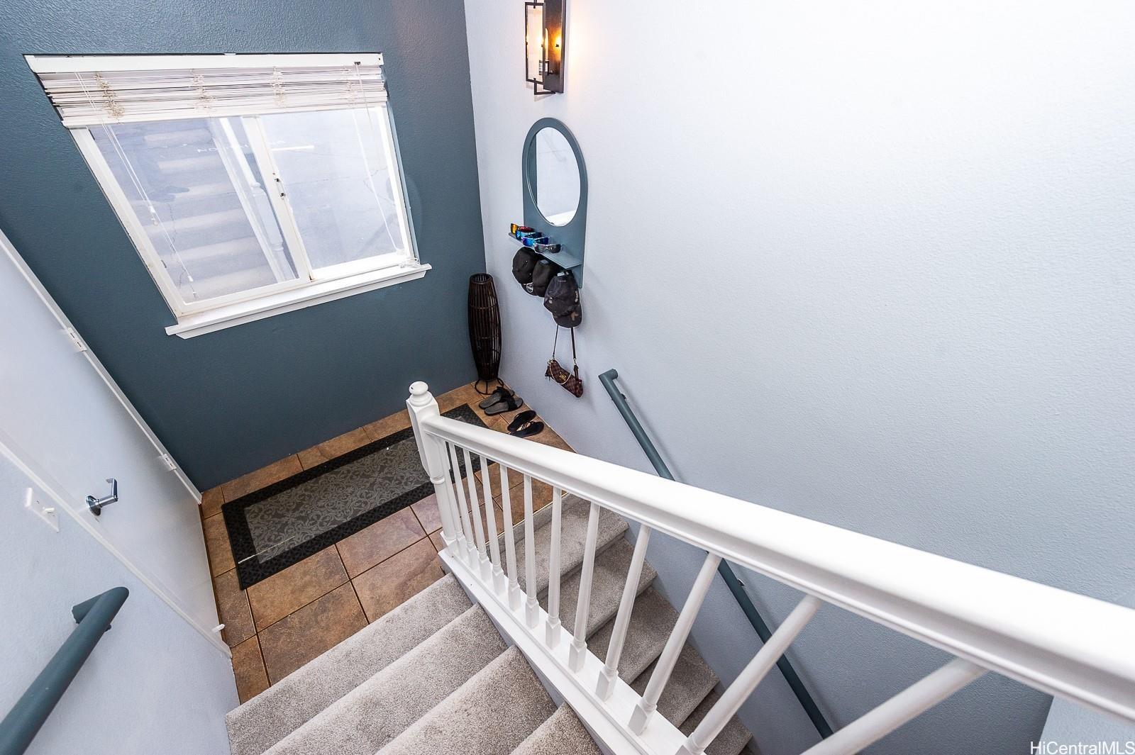 92-7049 Elele Street, Unit 81 Kapolei, HI 96707 - Photo 12 of 21 a view of staircase with railing and white walls