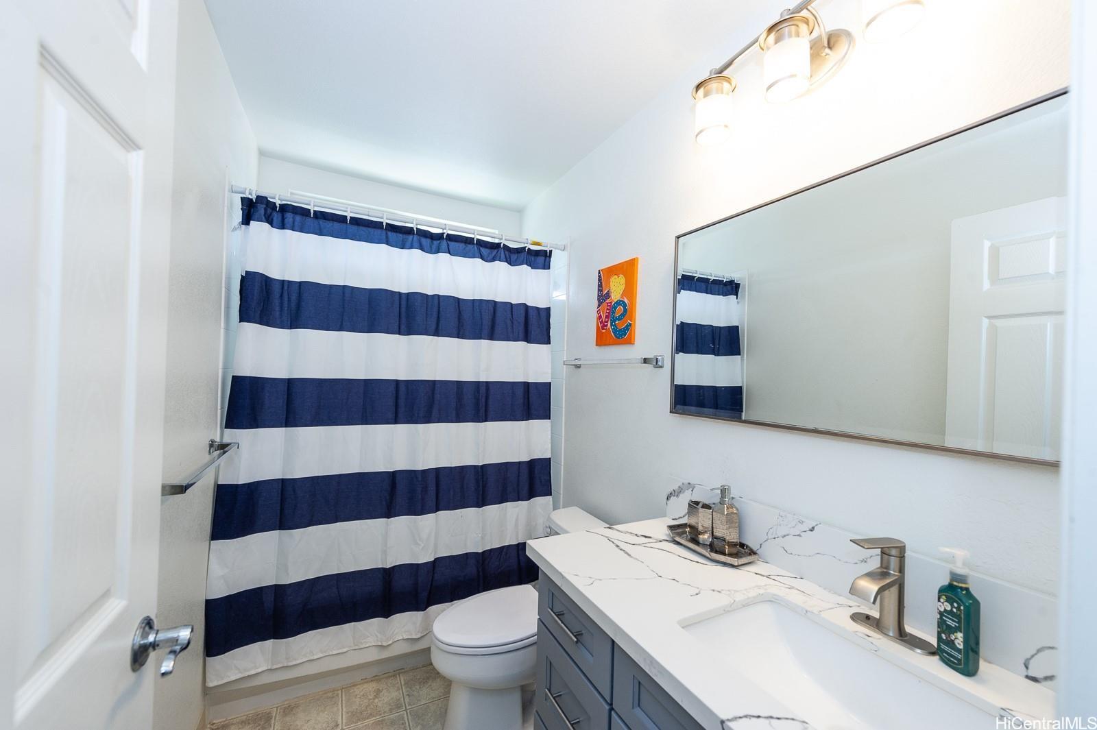 92-7049 Elele Street, Unit 81 Kapolei, HI 96707 - Photo 14 of 21 a bathroom with a sink toilet and shower