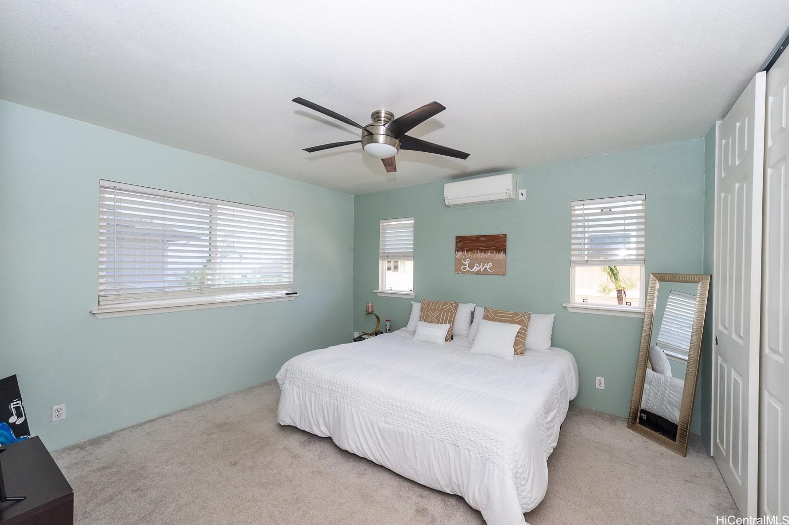 92-7049 Elele Street, Unit 81 Kapolei, HI 96707 - Photo 15 of 21 a bedroom with a large bed and a window