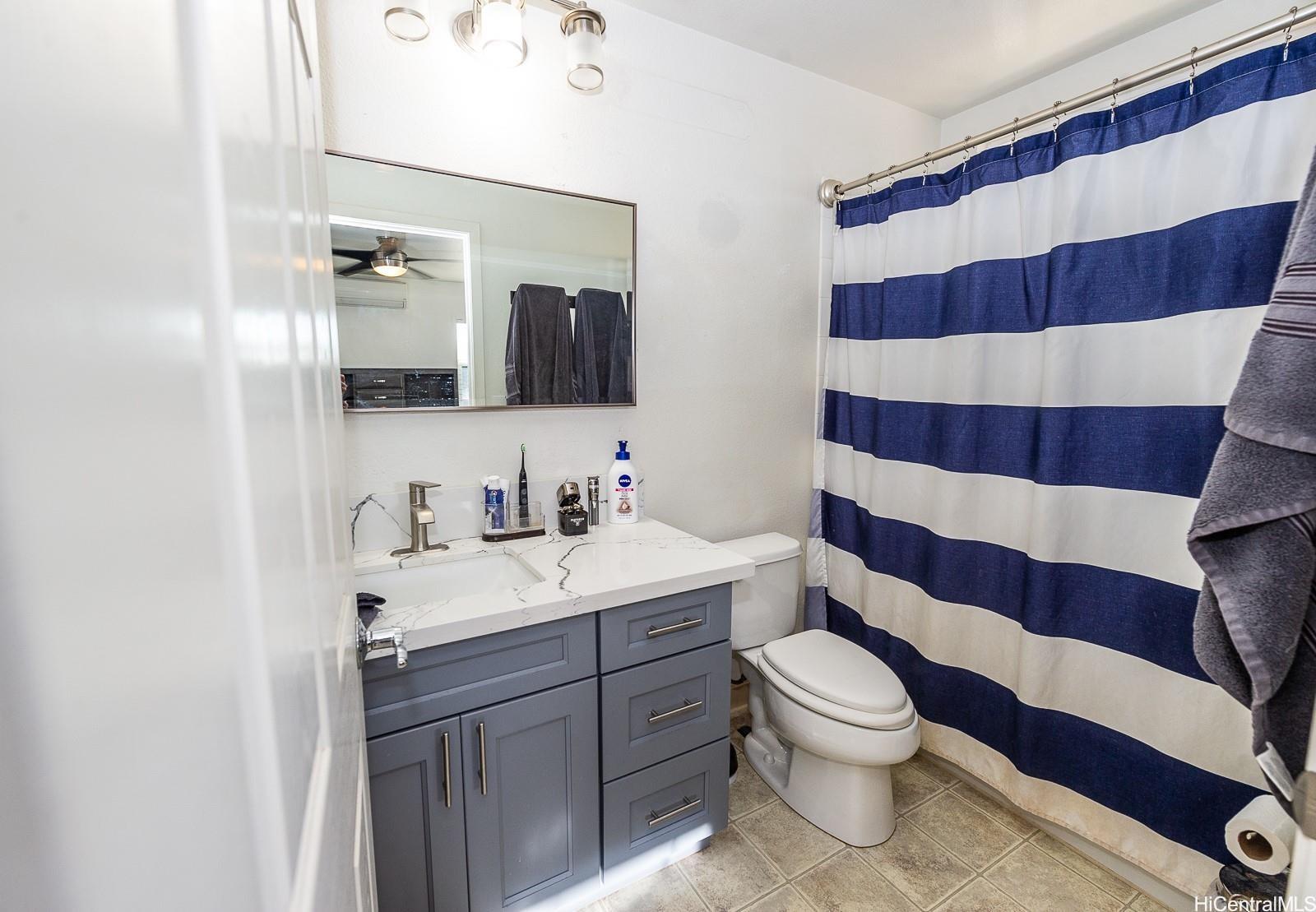 92-7049 Elele Street, Unit 81 Kapolei, HI 96707 - Photo 17 of 21 a bathroom with a sink and mirror