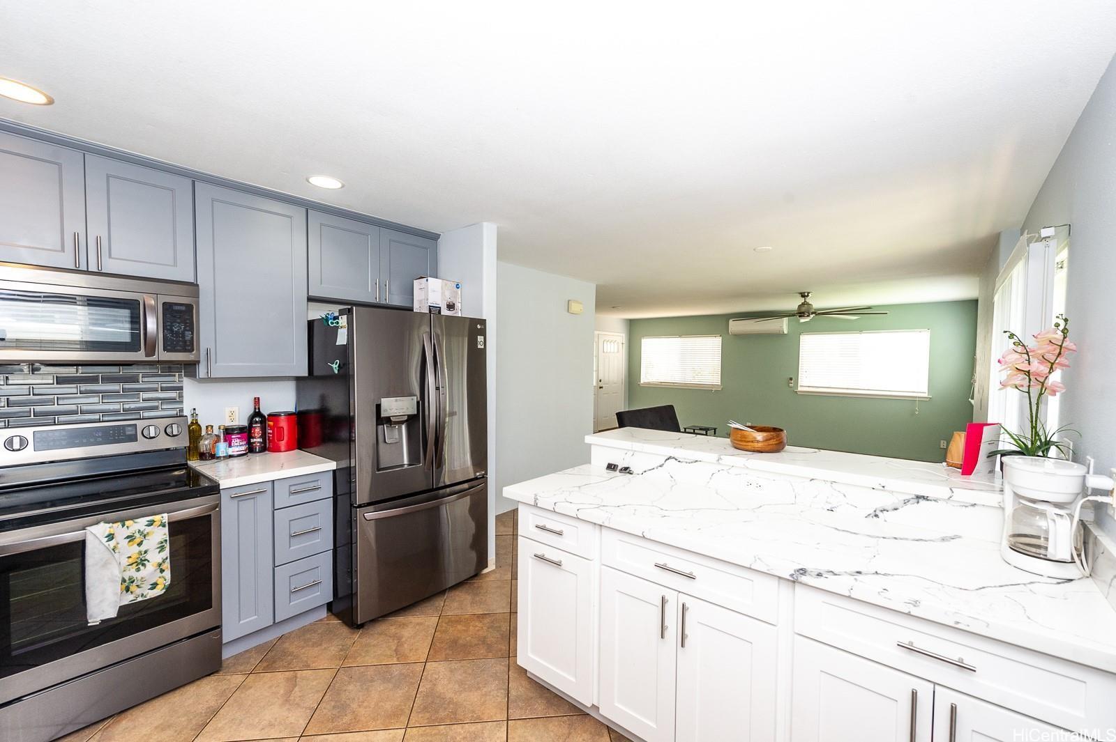 92-7049 Elele Street, Unit 81 Kapolei, HI 96707 - Photo 8 of 21 a kitchen with a sink appliances and cabinets