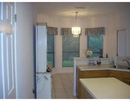 a bathroom with a tub a sink and mirror