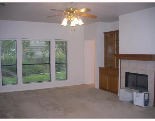 a view of an empty room with a fireplace