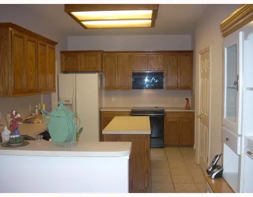 a kitchen with a sink cabinets and a window