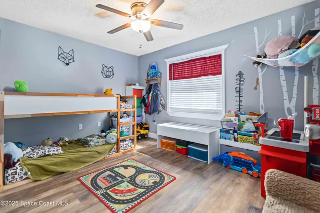 a bed room with furniture and a baby crib