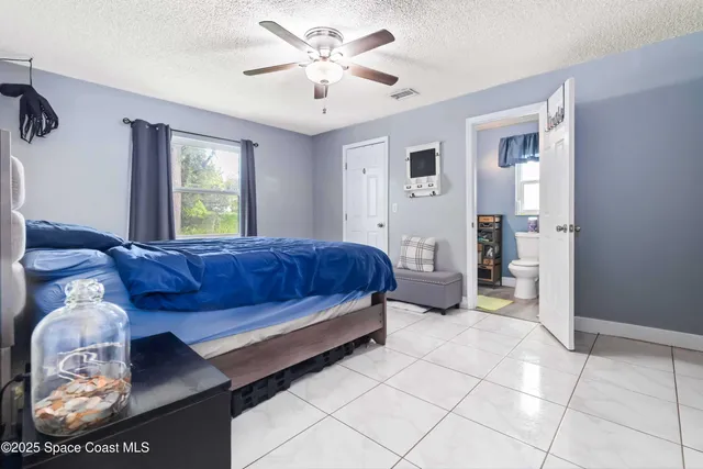 a living room with a couch and a chandelier