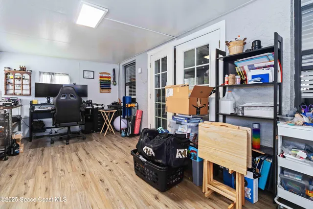 a living room with furniture and a book shelf