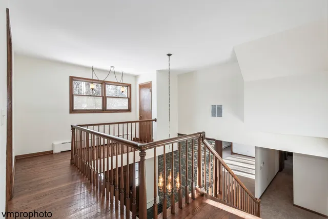 a view of entryway and hall with wooden floor