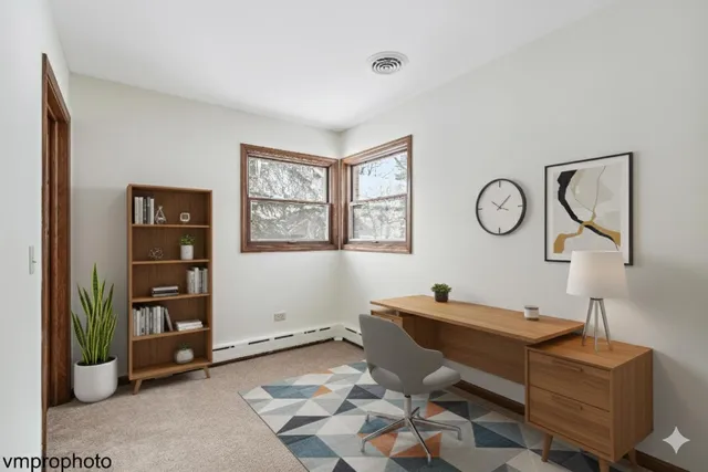 a view of a workspace with lounge chair and a window