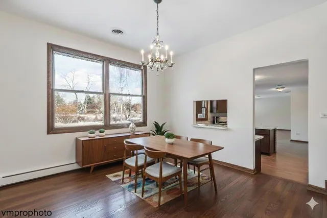 a view of a dining room with furniture window and wooden floor