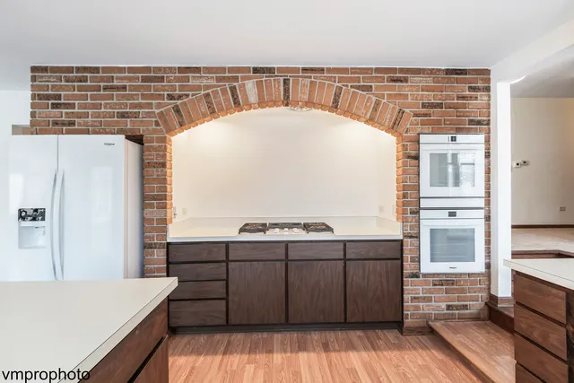 a view of kitchen with cabinets and wooden floor