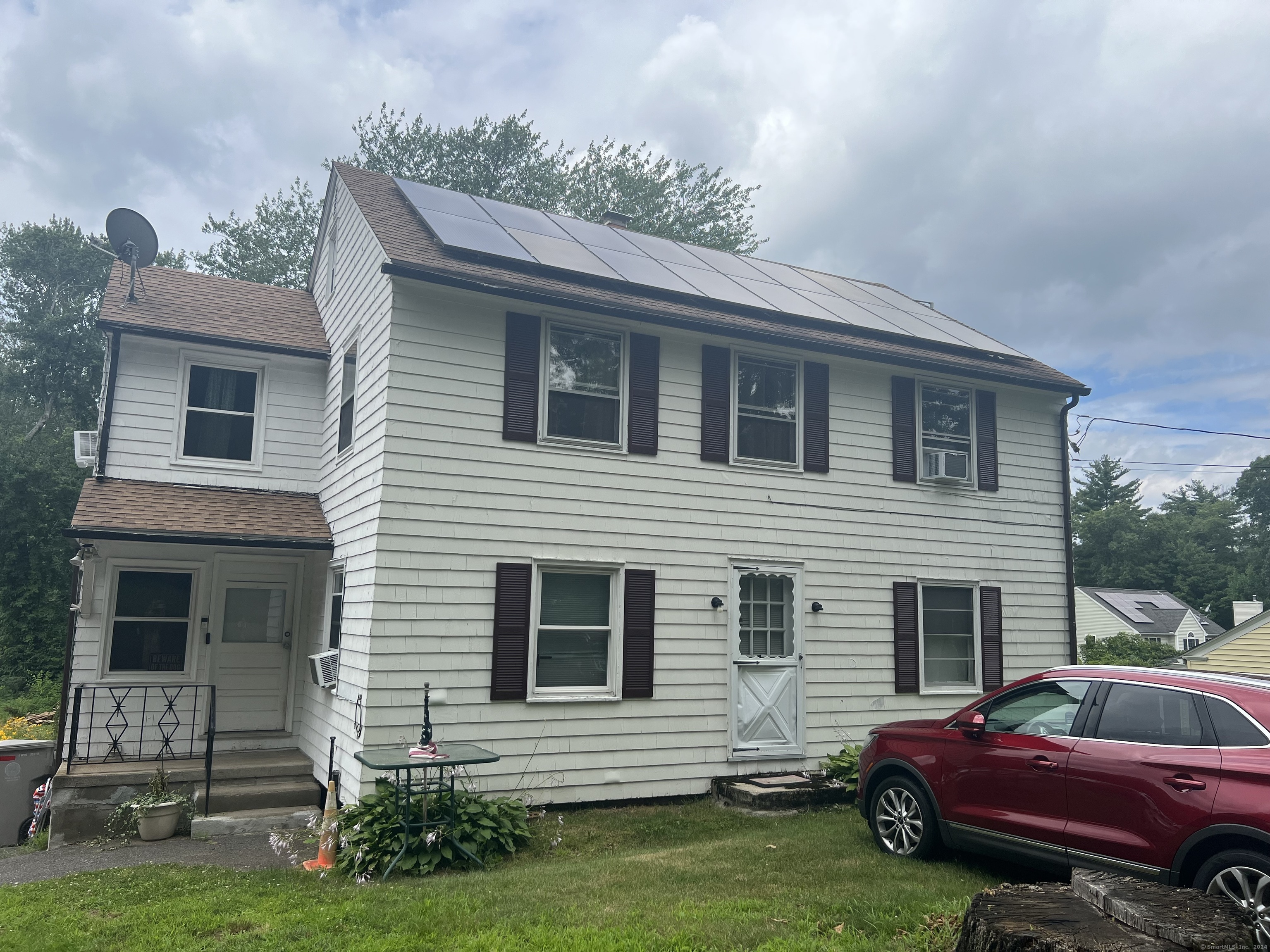 a front view of a house with a garden
