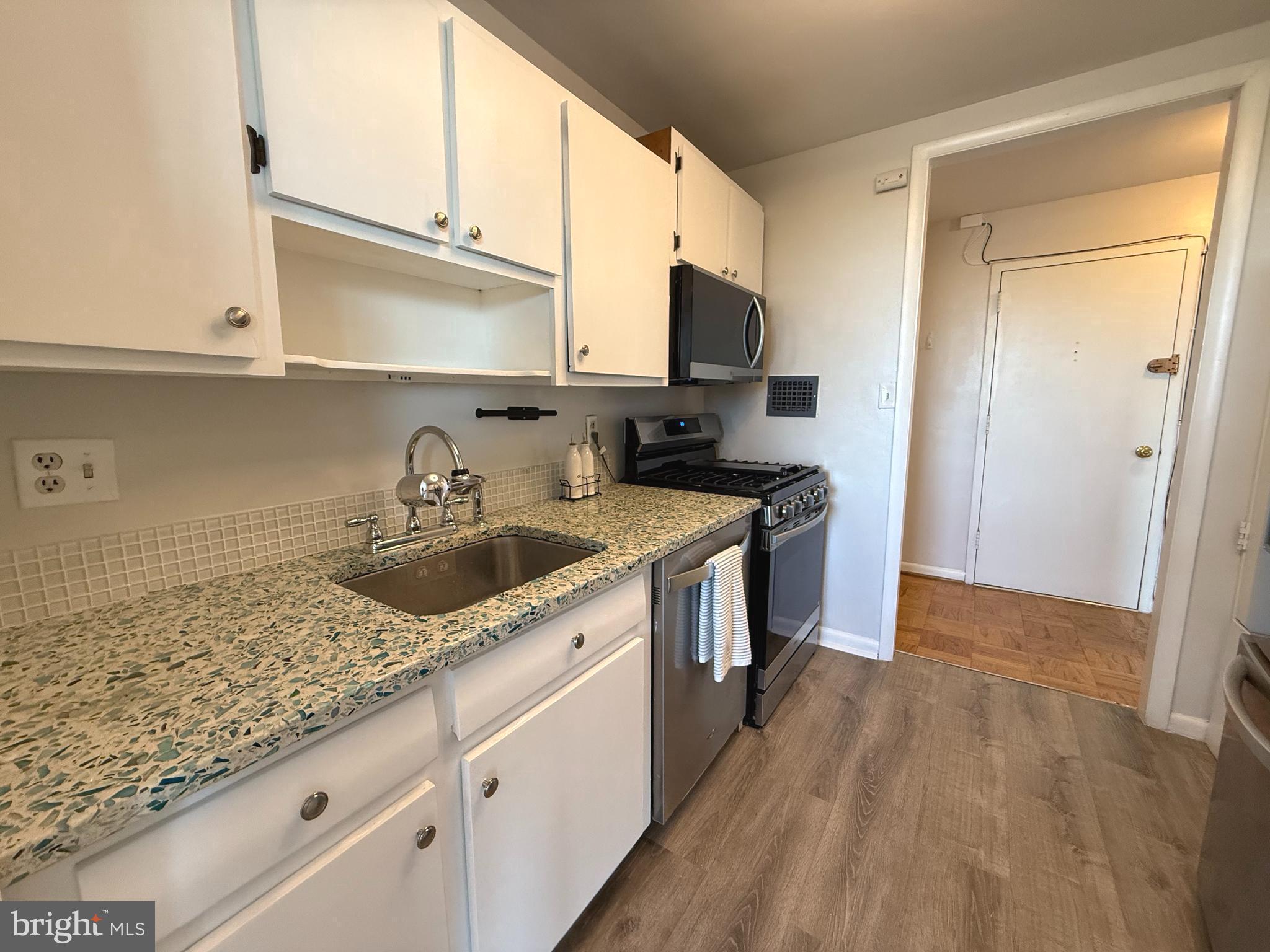 4343 Cherry Hill Road, Unit 705 Arlington, VA 22207 - Photo 4 of 38 a kitchen with a sink stove and cabinets