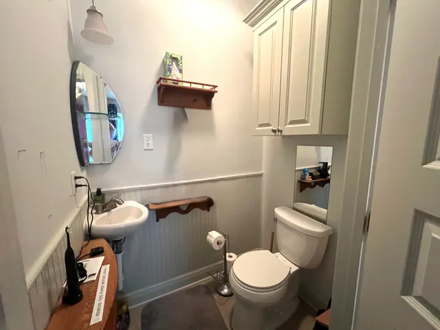 a bathroom with a toilet and a mirror