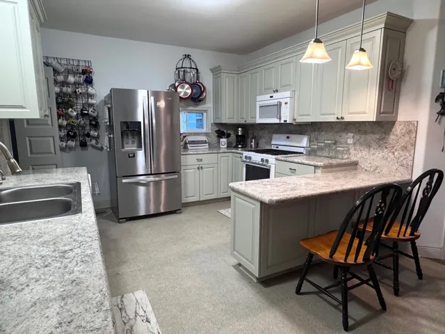 a kitchen with a refrigerator and a sink