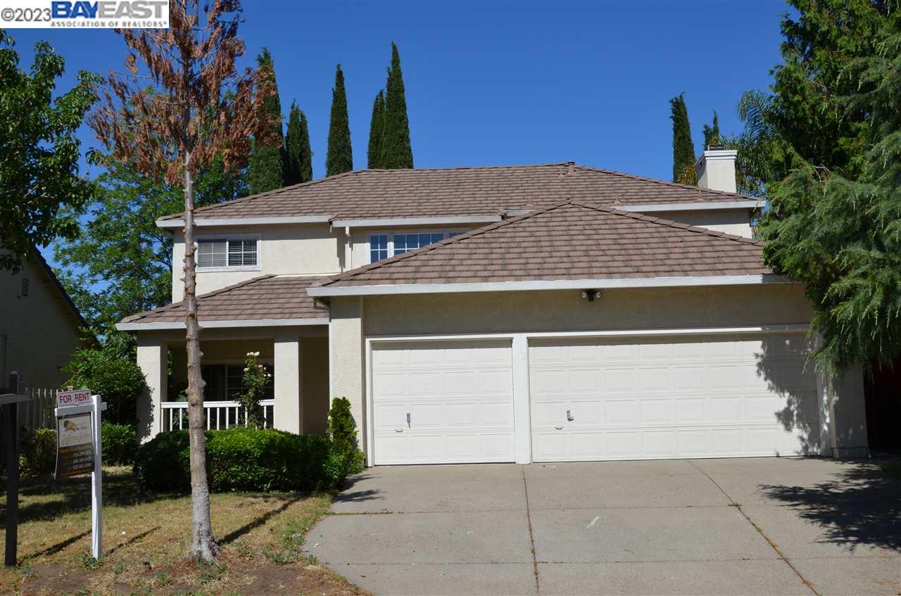 a view of house with outdoor space and a parking space