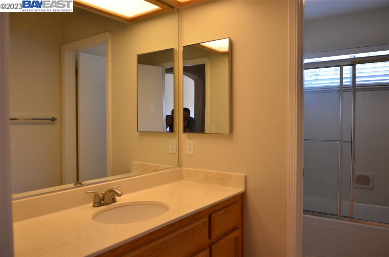 1463 Egret Drive Tracy, CA 95376 - Photo 14 of 19 a bathroom with a sink and a mirror