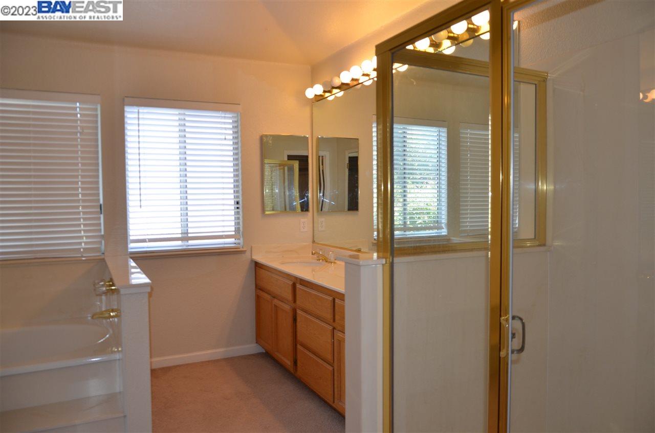 1463 Egret Drive Tracy, CA 95376 - Photo 17 of 19 a bathroom with a tub and a sink