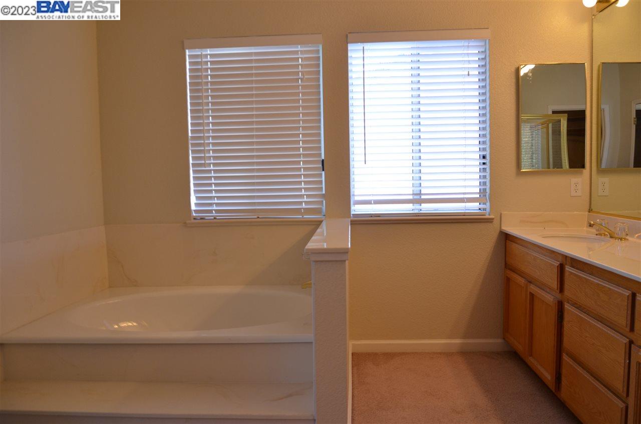 1463 Egret Drive Tracy, CA 95376 - Photo 18 of 19 a bathroom with a bathtub and a sink