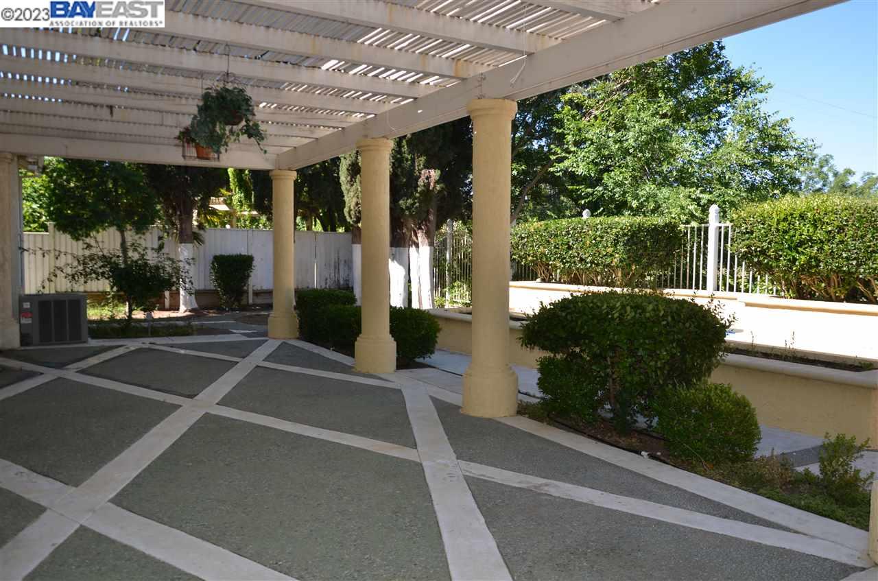 1463 Egret Drive Tracy, CA 95376 - Photo 2 of 19 a view of a patio with table and chairs under an umbrella