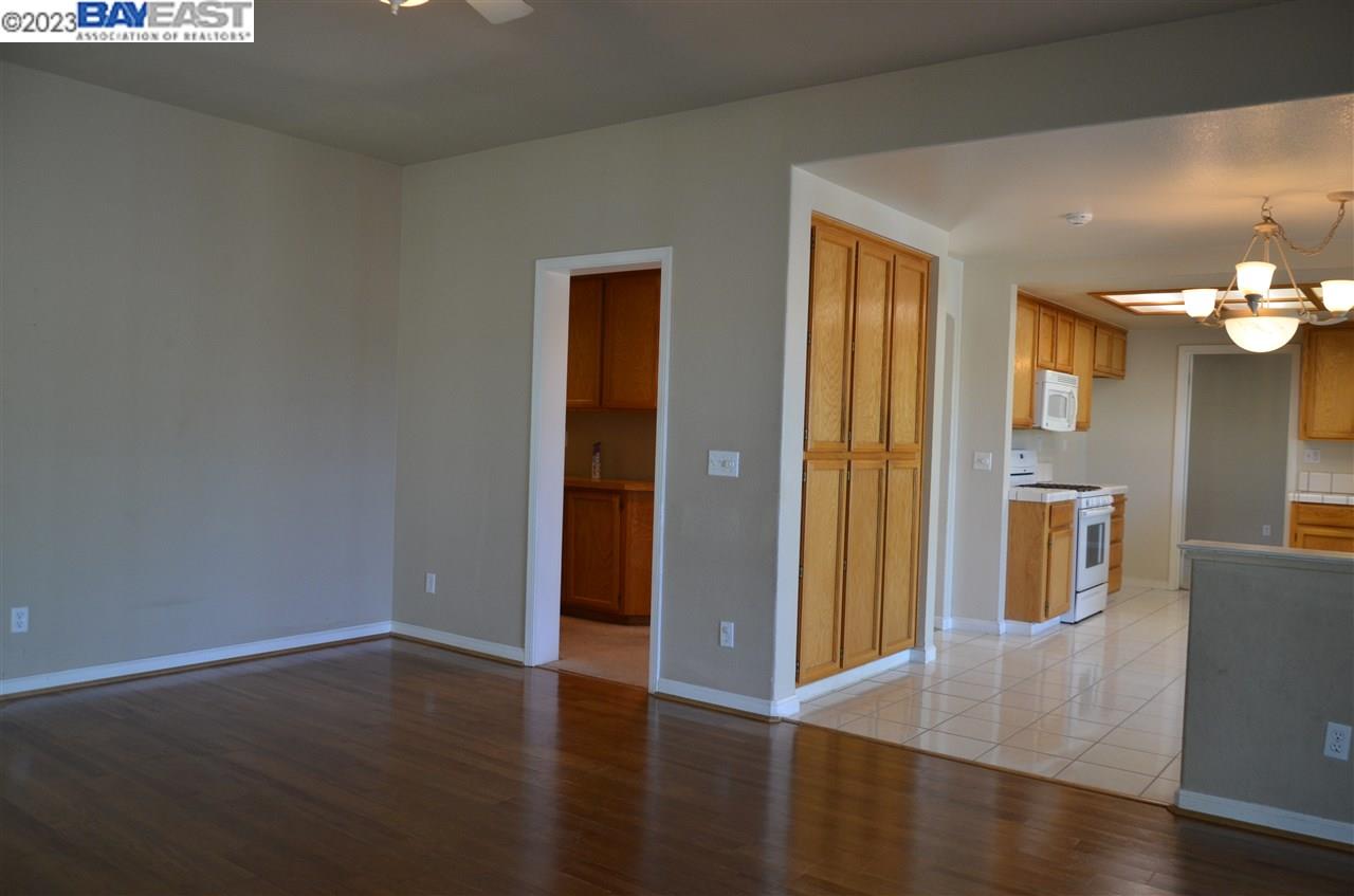 1463 Egret Drive Tracy, CA 95376 - Photo 6 of 19 an empty room with wooden floor and windows