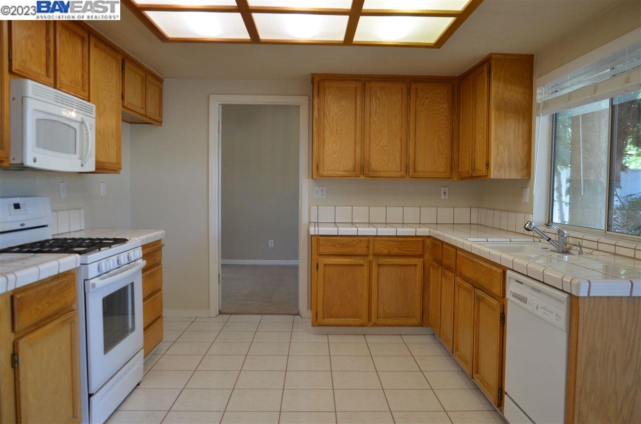 1463 Egret Drive Tracy, CA 95376 - Photo 7 of 19 a kitchen with a stove sink and cabinets
