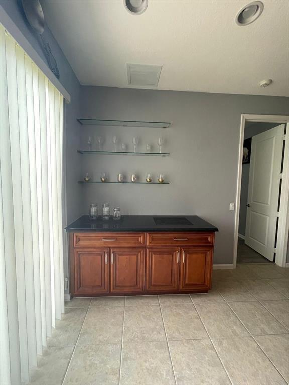 7445 Sarentino Lane, Unit 219 Boynton Beach, FL 33437 - Photo 4 of 12 a large kitchen with granite countertop cabinets and a sink