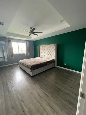 a spacious bedroom with a bed and a window