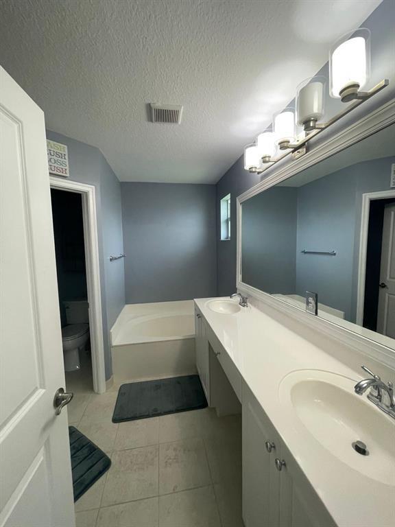 7445 Sarentino Lane, Unit 219 Boynton Beach, FL 33437 - Photo 6 of 12 a bathroom with a tub sink and a mirror
