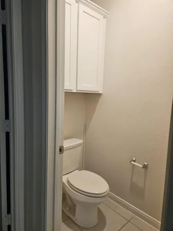 a white toilet sitting next to a shower