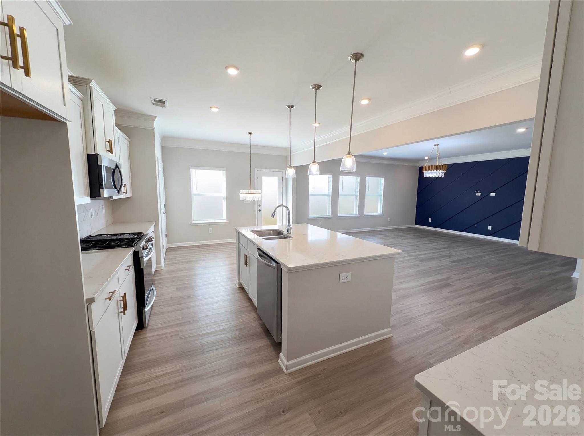 617 Ardsley Drive Locust, NC 28097 - Photo 15 of 23 a large white kitchen with wooden floor and a sink
