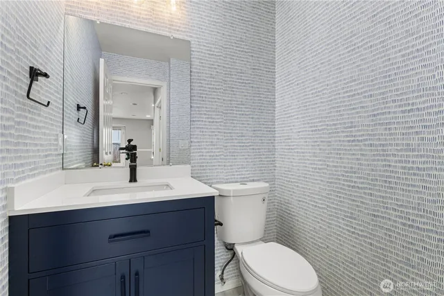 a spacious bedroom with a bed and a large mirror